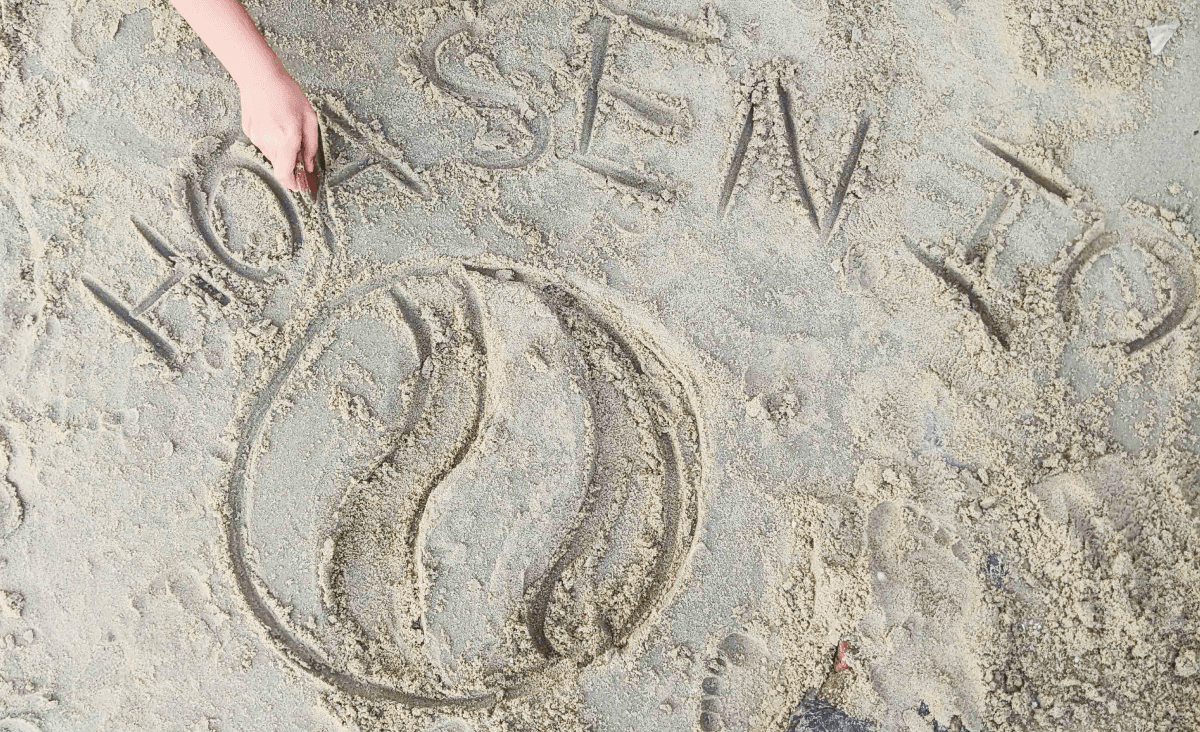 Hoasen logo in the sand